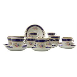 Late Victorian tea ware comprising eleven cups, twelve saucers, twelve cake plates, waste bowl, cake platter with bow detailing, decorated with sprays of pink and blue flowers with cobalt blue banding and gilding (37)