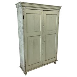 Victorian painted pine larder cupboard, projecting cornice over two panelled doors enclosing three shelves, raised on turned feet, in pale laurel green finish