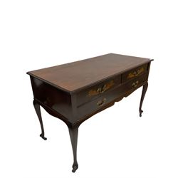 Late Victorian mahogany dressing side table, the rectangular top over two short and one long drawer with floral satinwood inlay, raised on cabriole supports, terminating in ceramic castors 