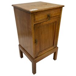Late 19th century Arts & Crafts walnut bedside cupboard, rectangular moulded top over single drawer and panelled cupboard, with brass drop handles and stylised flower head plates, lower moulded edge over square feet, panelled back  