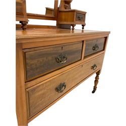 Edwardian walnut dressing chest, the mirror back over three drawers, raised on turned supports, terminating in ceramic castors 