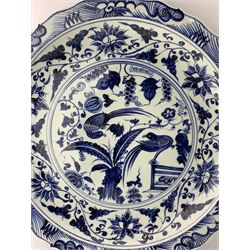 Pair of large Chinese blue and white circular shallow chargers, one centrally painted with exotic birds in a flowering tree surrounded by fruit and foliage, the other with Mandarin ducks in a lotus pond, both enclosed within a scrolling lotus border and shaped rim, D51cm 