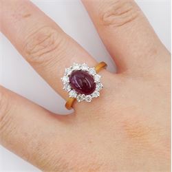 18ct gold oval cabochon ruby and round brilliant cut diamond cluster ring, hallmarked, ruby approx 3.20 carat, total diamond weight approx 0.30 carat