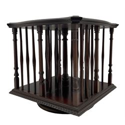Edwardian mahogany tabletop bookcase, shaped moulded top over turned spindle balestrade and stepped square columns, on circular revolving base 
