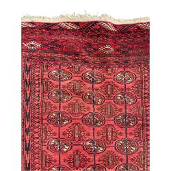 Persian Bokhara red ground rug, the field decorated with three rows of Gul motifs, multiple band border decorated with stylised motifs and geometric patterns