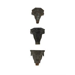 A harlequin set of six late 19th to early 20th century iron rainwater hopper heads