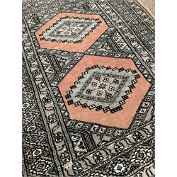 Small Persian rug of floral design, red field and bordered (140cm x 96cm) together with two small Bokhara rugs