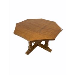 Robert 'Mouseman' Thompson of Kilburn - Yorkshire oak coffee table, the octagonal adzed top raised on four faceted octagonal supports leading to a cruciform base, pegged construction and carved with mouse signature W91cm, H48cm