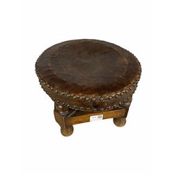 Oak footstool with oval studded leather top on short supports