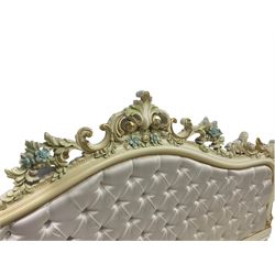 Italian classical or baroque style ivory painted 5' king-size divan surround, the headboard decorated with a central cartouche and extending scrolling with gilt and painted flowerheads and pierced foliate moulding, head and footboard upholstered in button ivory fabric