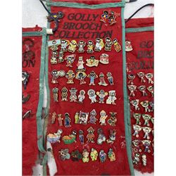 Golly Brooch Collection, a quantity of enamel brooches on red felt banners, some a/f