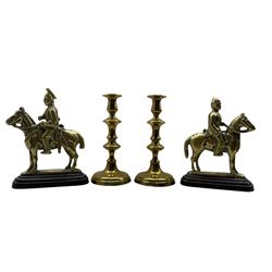Pair of Victorian brass hearth ornaments in the form of soldiers on horseback H26cm and a pair of brass candlesticks