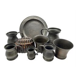 Two 19th century bronze mortars H10cm, Victorian copper jelly mould, five Victorian graduated pewter measures and a pewter plate