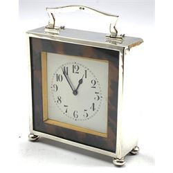 Silver cased mantle clock with white dial surrounded by tortoiseshell banding with loop handle and ball feet H10cm Birmingham 1923 Maker Horton & Allday