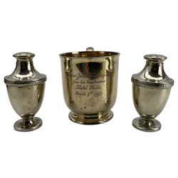 Silver christening mug with gilded interior and inscription London 1917 Maker Garrard & Co, in fitted case; and a pair of silver pepperettes, Sheffield 1918 Maker Walker & Hall 