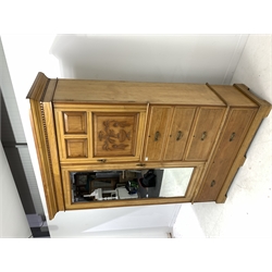 Late Victorian satin walnut wardrobe, the left hand side enclosed by bevelled  mirror door, two carved panel cabinet doors enclosing shelves above five graduating drawers, shaped plinth base