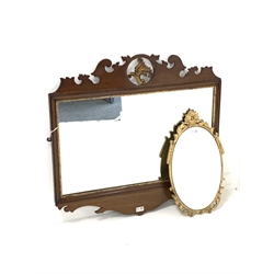 Late 19th/early 20th century Chippendale style mahogany fret cut mirror, floral scrolled pediment centred with gilt acanthus leaf, rectangular plate enclosed by gilt moulded slip, shaped apron (78cm x 81cm) together with a 20th century Atsonea gilt framed oval wall mirror (51cm x 30cm)
