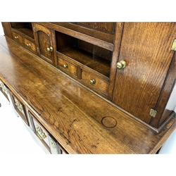 George III oak dresser, dentil cornice over open shelves and cupboards, three drawers under, raised on turned front supports,  W190cm, H187cm, D52cm