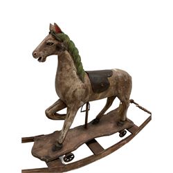 Small rocking horse, with leather saddle raised on a rocking base 