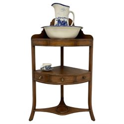 George III mahogany three-tier corner washstand, shaped raised back over bowl and twin beaker rests, fitted with single drawer with two flanking faux drawers, with ceramic bowl and jug