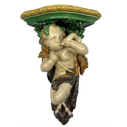 Early Victorian Minton Majolica wall bracket designed by Albert Carrier Belleuse, modelled as a Faun with a hunting horn, carrying a fox on his shoulder, with egg and dart shaped platform, stamped verso, 1842, H50cm x W30cm