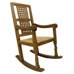 Mouseman - oak rocking armchair, double pierced and carved lattice back, upholstered in tan leather with stud work, octagonal front supports, carved with mouse signature, by the workshop of Robert Thompson, Kilburn 