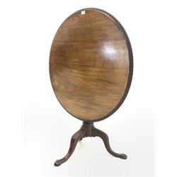 Georgian style occasional table, circular tilt top with floral moulded edge raised on turned column and leaf carved triple splay supports with ball and claw feet D91cm