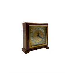 A compact mid-20th century English mantle clock in a square walnut case on raised feet, square brass dial with spandrels and silvered chapter ring, Roman numerals, five-minute Arabic’s, with a minute track and inner quarter hour track, steel serpentine hands within a square brass bezel and bevelled glass, spring driven movement by Elliot, London, with a balance wheel escapement and integral winding key.



