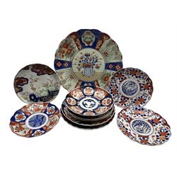 Mid 19th century Japanese dish, enamelled in the imari palette with a fenced garden D21.5cm, together with various sized Japanese Imari chargers and plates, c1900 and later D36cm max (10)