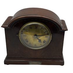 An American early 20thth century eight-day mantle clock in a mahogany case striking the hours and half hours on a coiled gong, movement by William Gilbert, Winchester, Connecticut, USA, inlaid dome shaped case on a moulded pediment with bun feet, brass dial (formerly silvered) with Roman numerals, minute track and steel spade hands within a spun bezel with a convex glass, presentation plaque attached to the front of the case. With pendulum. 



