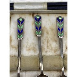 Set of six silver coffee spoons with blue and green enamel terminals, cased Birmingham 1935 Maker Walker and Hall and a set of six silver gilt and enamel coffee spoons marked 'Denmark Sterling' 
