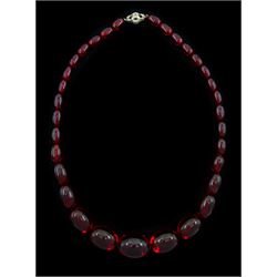 Graduated red bakelite oval bead necklace on a fancy rose cut diamond set clasp stamped 9ct