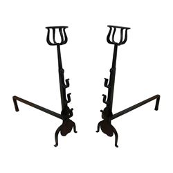 Pair of wrought iron fire dogs or andirons, cresset top over plain tapered stems mounted by spit rests and shaped plates, on curved out-splayed front feet