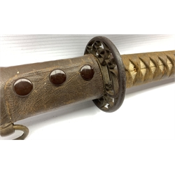 World War II Japanese officers sword with curved blade and iron tsuba, cotton wound shagreen grip and floral menuki in leather covered scabbard, length of blade 66cm