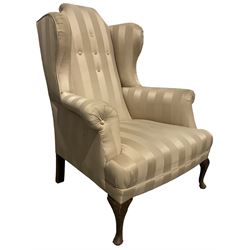 Victorian wingback armchair upholstered in later fabric, raised on cabriole supports 