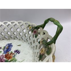 Large Meissen porcelain oval fruit basket, with two naturalistic entwined handles, terminating with encrusted flowers and foliage, the interior hand painted with floral sprays and insects, the exterior painted with blue flower heads, crossed swords mark beneath (a/f) L40cm 