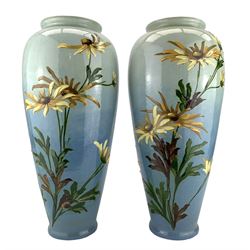 Pair of Burmantofts Faience vases, of shouldered ovoid form, each slip decorated with stems of yellow flowers against a graduated sky blue ground, impressed factory marks beneath, shape no. 1316, model no. 6028, H42cm