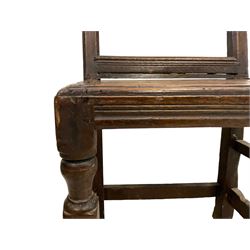 17th century oak backstool, the back panel carved with twin rosettes in a foliate edged border, the panelled seat over a plain front rail, raised on turned front supports united by a box stretcher