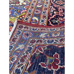 Fine Hand Knotted Persian Kashan carpet, the red field decorated with deep blues, greens and ivory and bordered 295cm x 390cm 