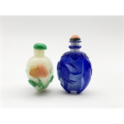 Chinese Peking glass snuff bottle decorated in blue glass overlay with an Elephant and coral coloured stopper, H7cm, together with another Peking glass scent bottle decorated with flowers (2)