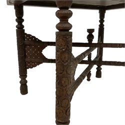 20th century Indian carved hardwood table, with inset brass tray decorated with peacocks, the folding base carved with flower heads