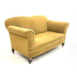 Early 20th century two seat drop arm sofa, upholstered in yellow velvet, raised on shaped square section supports terminating in castors W147cm, H82cm, D83cm