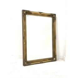 20th century wall mirror of classical design, the bevelled plate enclosed by floral moulded swept gilt frame 76cm x 107cm