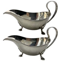 Pair of silver sauce boats with loop handles on triple shaped supports Sheffield 1935 Makers Mark R.G & S 