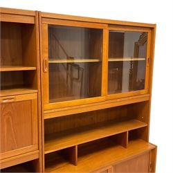 Mid-20th century teak two sectional wall unit, fitted with fall front, sliding glass doors, sliding panelled doors, shelves and drawers