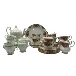 Royal Albert tea set comprising seven cups, six saucers, side plates, cream jug, sugar bowl and cake plate together green polka dot tea ware comprising cups, saucers, teapot etc. 