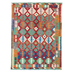 Anatolian Turkish Kilim multi-coloured rug, the crimson field decorated with all-over hexagonal lozenges of contrasting colours, enclosed by a multi-band border of geometric design
