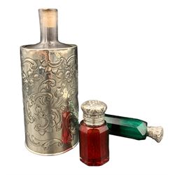 Victorian emerald green glass double-ended scent bottle, one end with a white metal cover embossed with a four-leaf clover L10cm, Victorian faceted ruby glass scent bottle with white metal cover embossed with grapes and a further scent bottle with silver holder, total weighable silver 2.2 ozt (3)