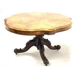 Victorian burr walnut loo table, the well figured quarter sawn veneered serpentine top raised on turned pedestal and four leaf carved and splayed supports terminating in ceramic castors, 113cm x 150cm, H175cm