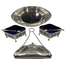Pair of silver oval open salts with pierced sides, blue glass liners and shaped supports Birmingham 1919 Maker Cooper Bros. & Sons Ltd, a Victorian pierced silver oval sweetmeat dish with raised harebells W18cm Sheffield 1895 Maker James Dixon & Son and a silver purse engraved with a monogram and divided interior  (3)